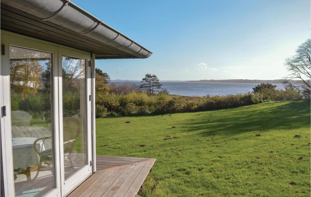a porch of a house with a view of the water at Amazing Home In Hundested With 3 Bedrooms, Sauna And Wifi in Hundested