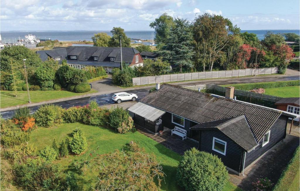 an aerial view of a house with a car parked in the driveway at Stunning Home In Augustenborg With Kitchen in Augustenborg