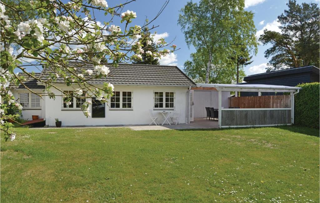 a white house with a lawn in front of it at Awesome Home In Silkeborg With 2 Bedrooms And Wifi in Silkeborg
