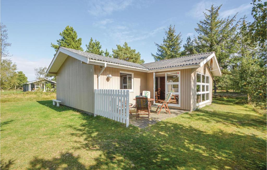 a tiny house with a porch and a yard at Amazing Home In Rm With Wifi in Bolilmark