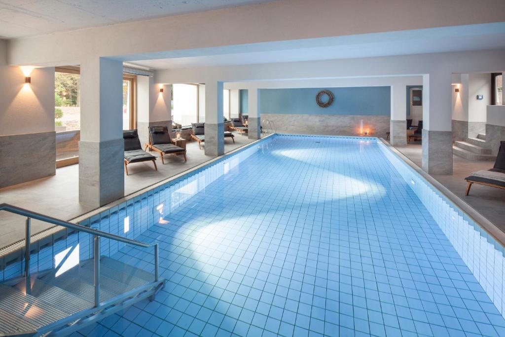 a large swimming pool in a hotel room at Buchnas Landhotel Saarschleife in Mettlach