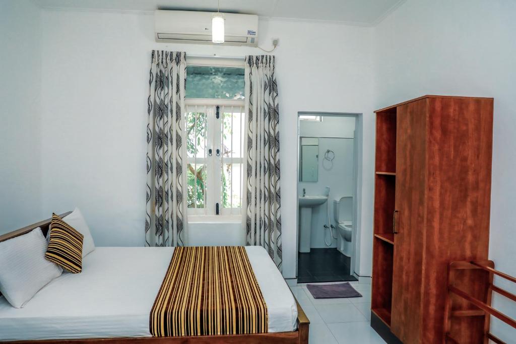 Ein Bett oder Betten in einem Zimmer der Unterkunft Bon Voyaage Tourist Inn