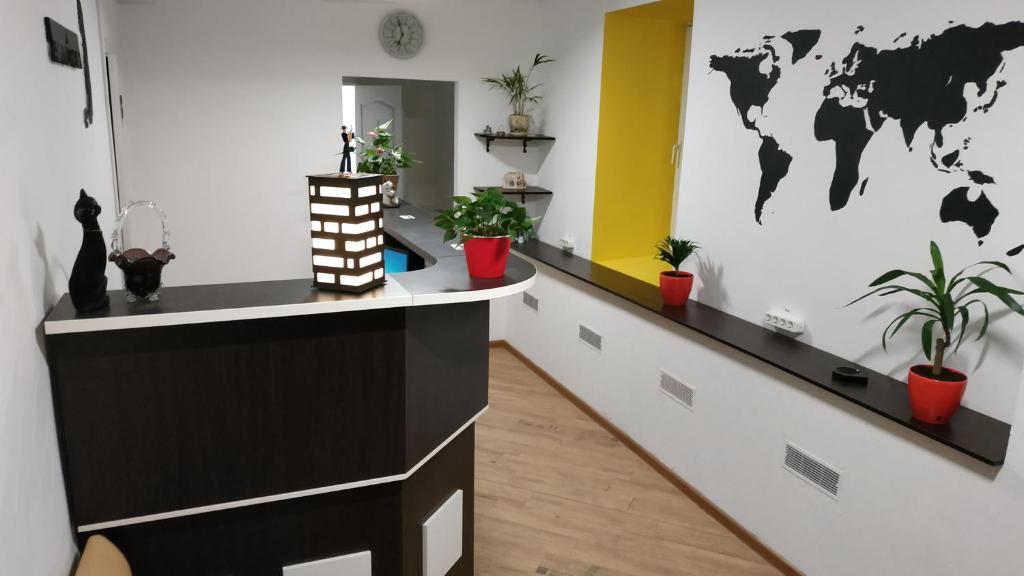 a office with a desk with plants and a world on the wall at Cool Traveler in Kyiv