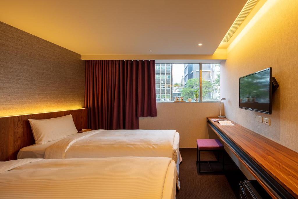Postel nebo postele na pokoji v ubytování Goodmore Hotel