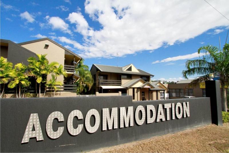 a sign in front of a house at Reef Gateway Hotel in Airlie Beach