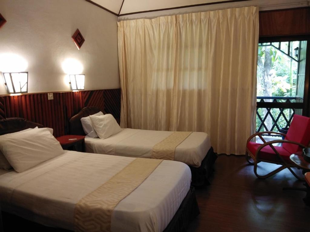 Postel nebo postele na pokoji v ubytování Sepilok Jungle Resort