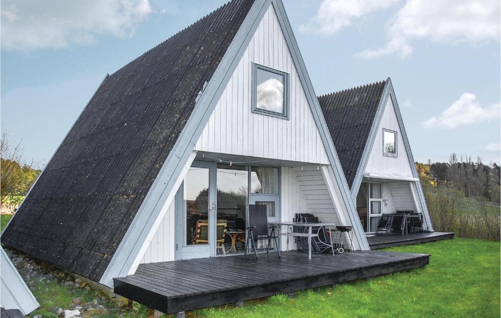 un granero blanco con techo negro en Stunning Home In Knebel With 3 Bedrooms, Outdoor Swimming Pool And Wifi, en Knebel