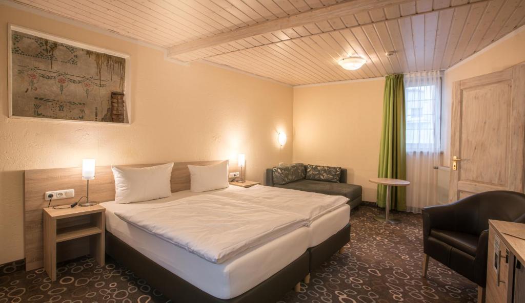 Postel nebo postele na pokoji v ubytování Hotel Wilder Mann