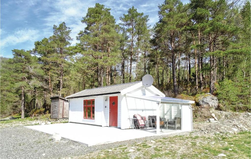 a small white shed with a red door at Gorgeous Home In Dirdal With Wifi in Dirdal
