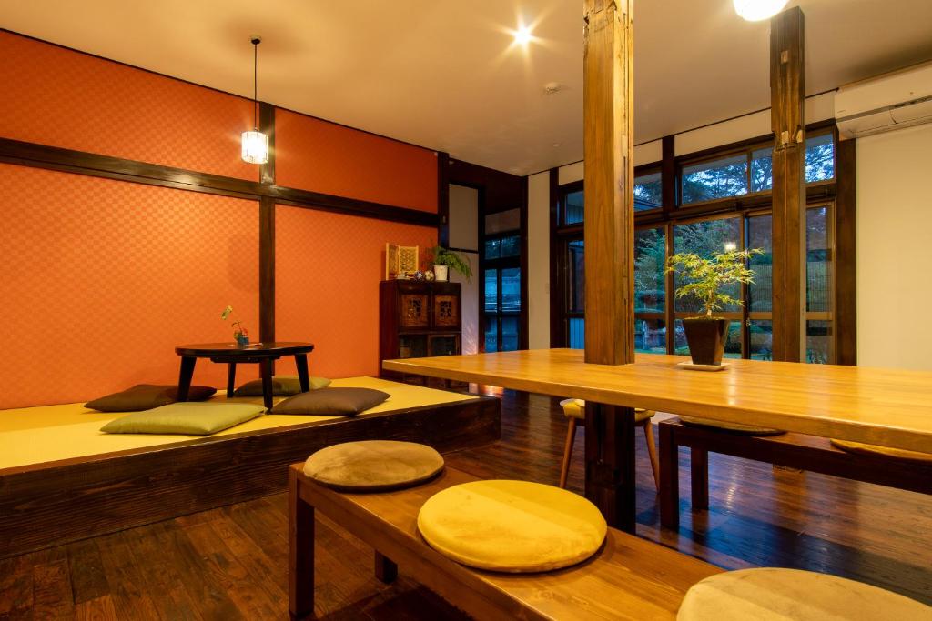 a room with tables and benches in a room at HOSTEL MICHIKUSA-YA in Fujikawaguchiko