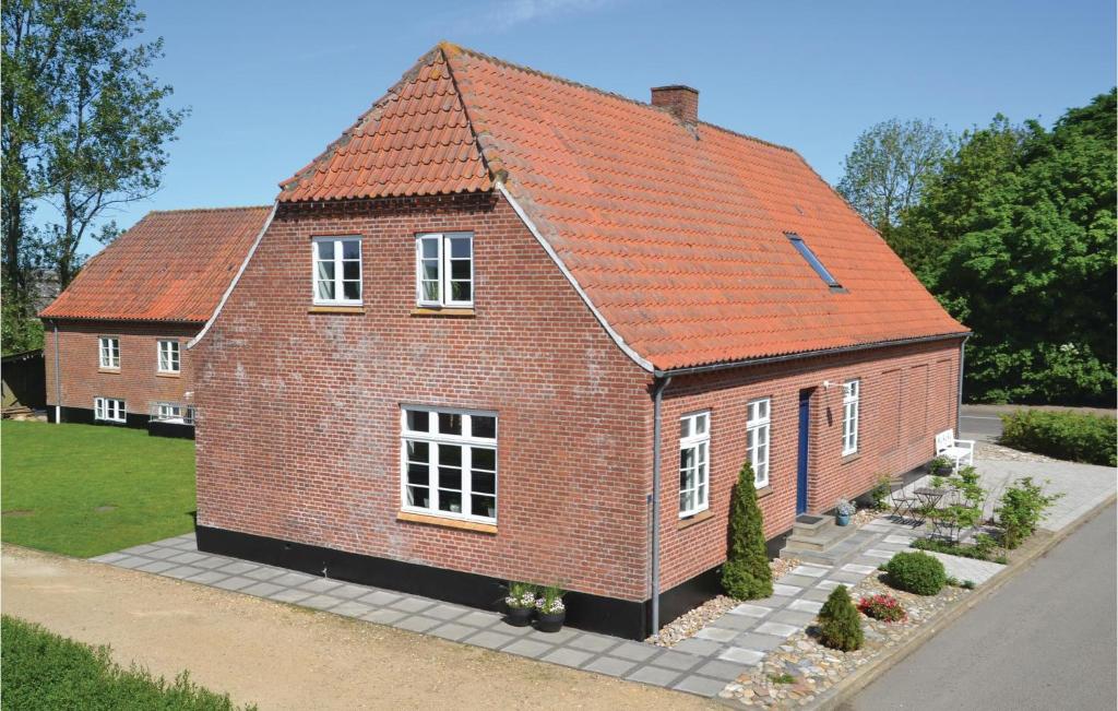 ein rotes Backsteinhaus mit orangefarbenem Dach in der Unterkunft Gorgeous Home In Outrup With Kitchen in Vester Debel