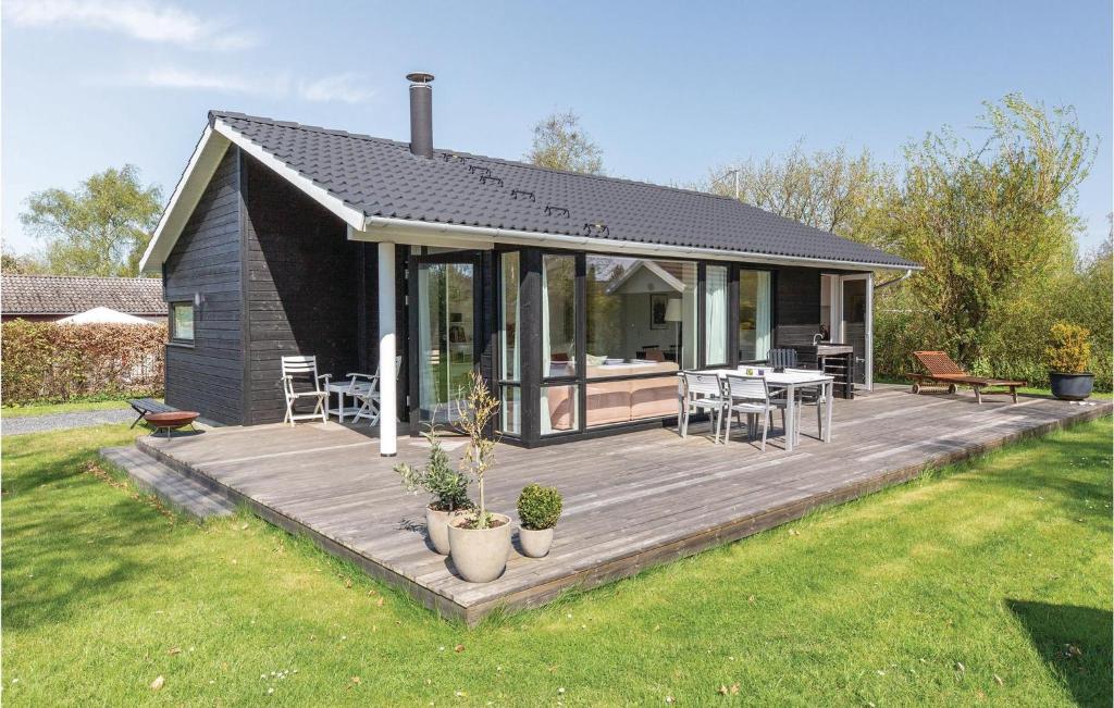 a house with a wooden deck in the yard at 3 Bedroom Stunning Home In Slagelse in Slagelse