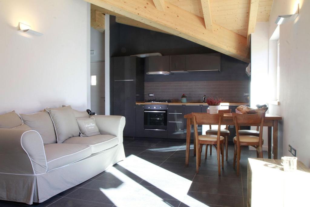 a living room with a white couch and a table at Dolomiti di Brenta House in Madonna di Campiglio