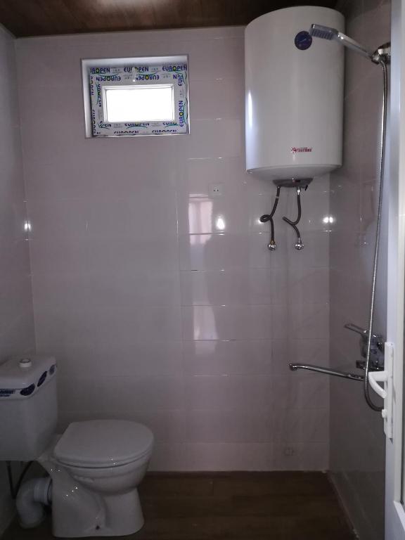 bagno con servizi igienici bianchi e finestra di Guest house lela a Mestia
