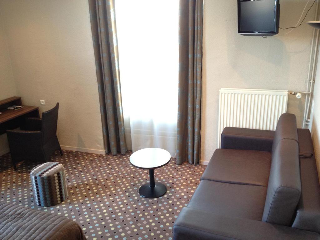 a living room with a couch and a table at LES ARCADES in Dieppe