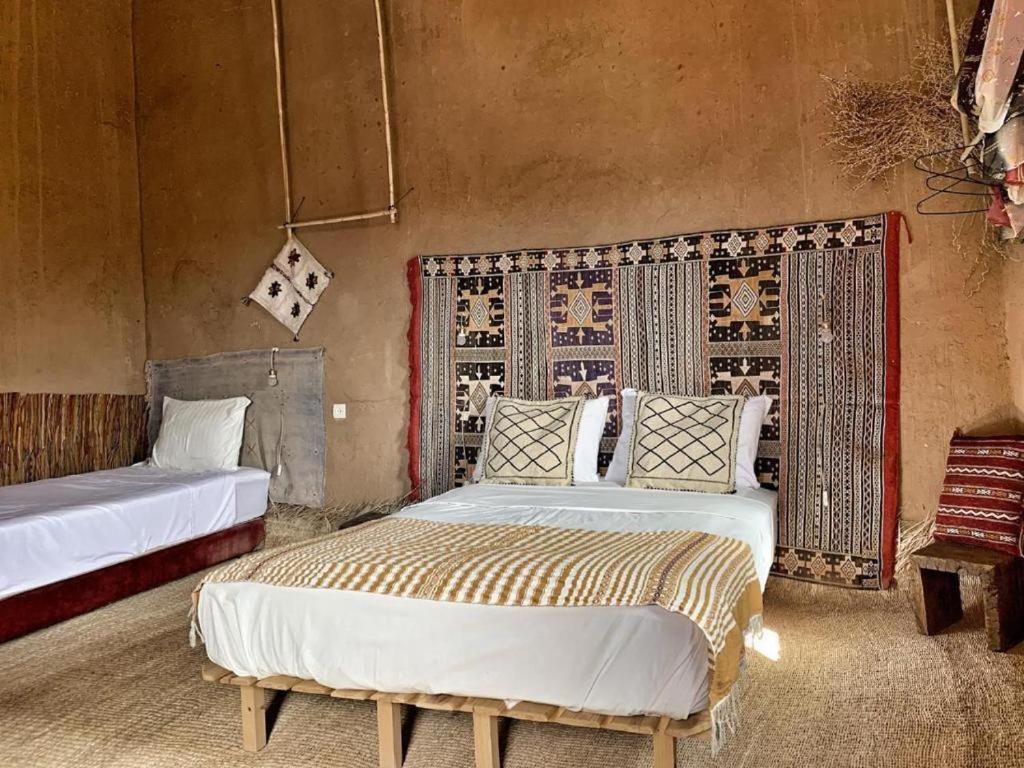 a bedroom with two beds in a room at Kasbah Oulad Othmane in Agoubt