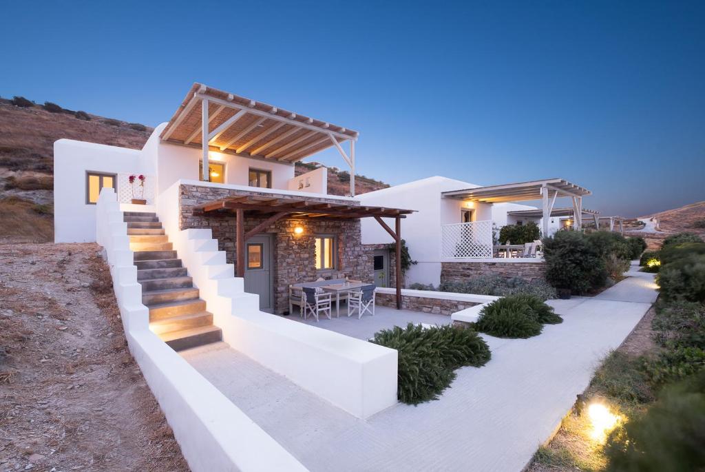 a villa with a staircase leading up to a house at Lagadia Village in Andiparos