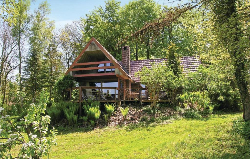 a house on a hill with trees and grass at Amazing Home In Asperup With Kitchen in Asperup