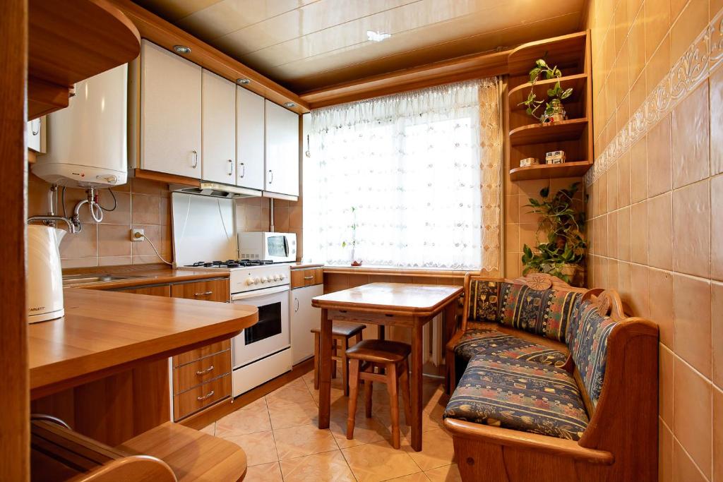 a kitchen with a table and a chair in a kitchen at Однокомнатные апартаменты в районе ТРЦ Фабрика in Kherson