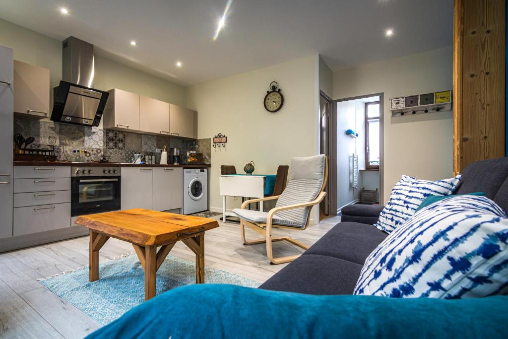 a living room with a couch and a table at LA LIESE in Niederbronn-les-Bains