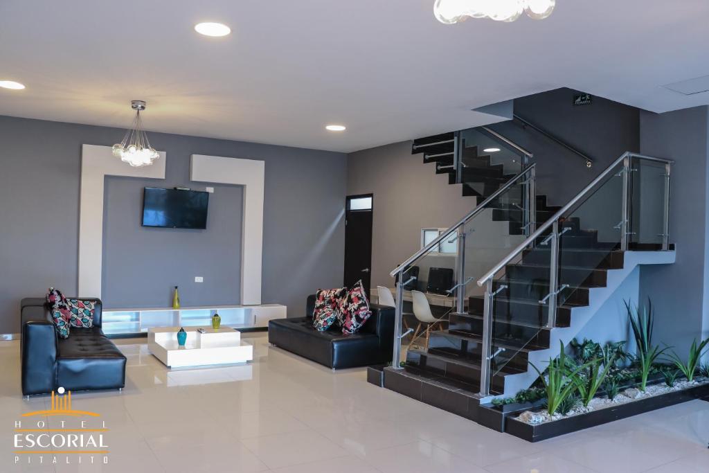 a living room with a staircase and a couch at HOTEL ESCORIAL PITALITO in Pitalito