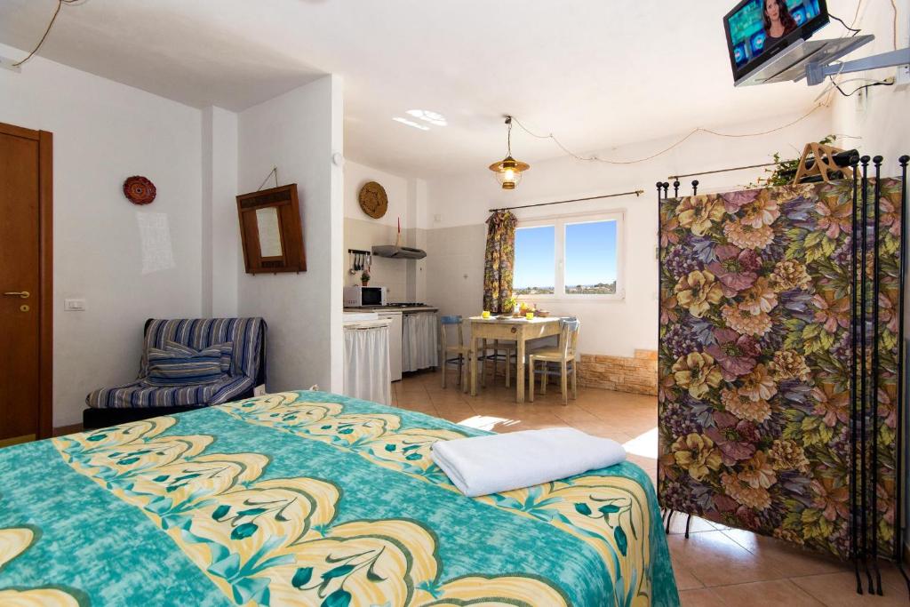 a bedroom with a bed and a chair and a table at Le Navi In Cielo in Imperia