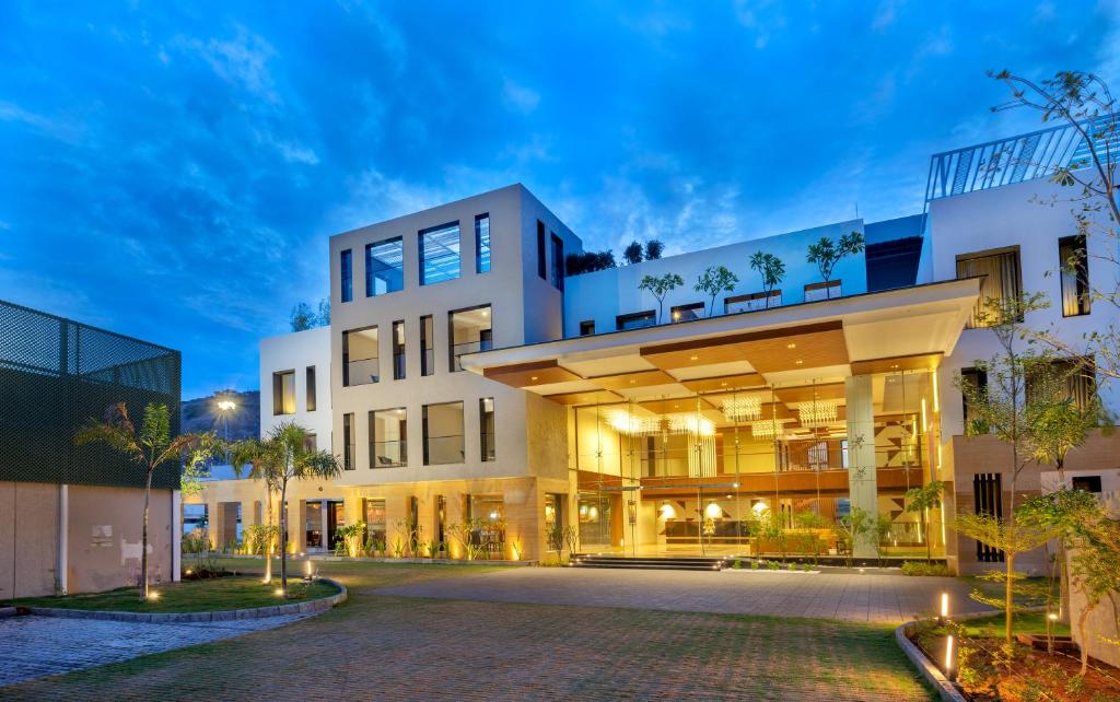 an exterior view of a building at night at Hotel Divine Fort in Palani