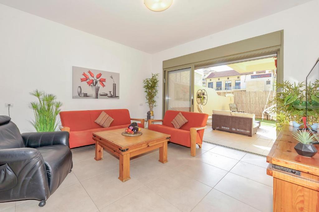 a living room with two couches and a coffee table at Family-Friendly Apartment in Zichron Yaakov in Zikhron Ya'akov