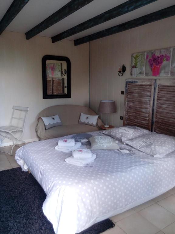 a bedroom with a large bed with towels on it at Domaine du mont scolan in Montgardon