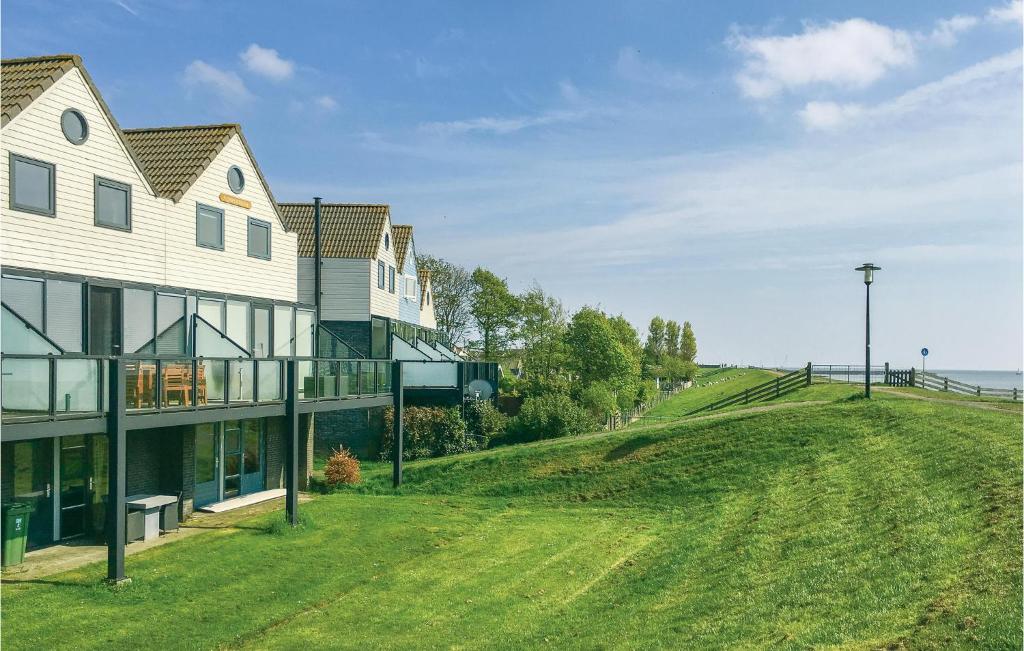 a house on a hill next to the ocean at Awesome Home In Stavoren With Wifi in Stavoren