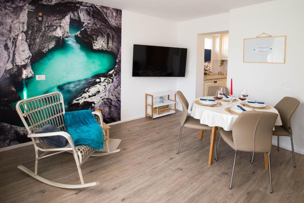 a dining room with a table and chairs and a tv at ALEX BUMBLEBEE in Bled