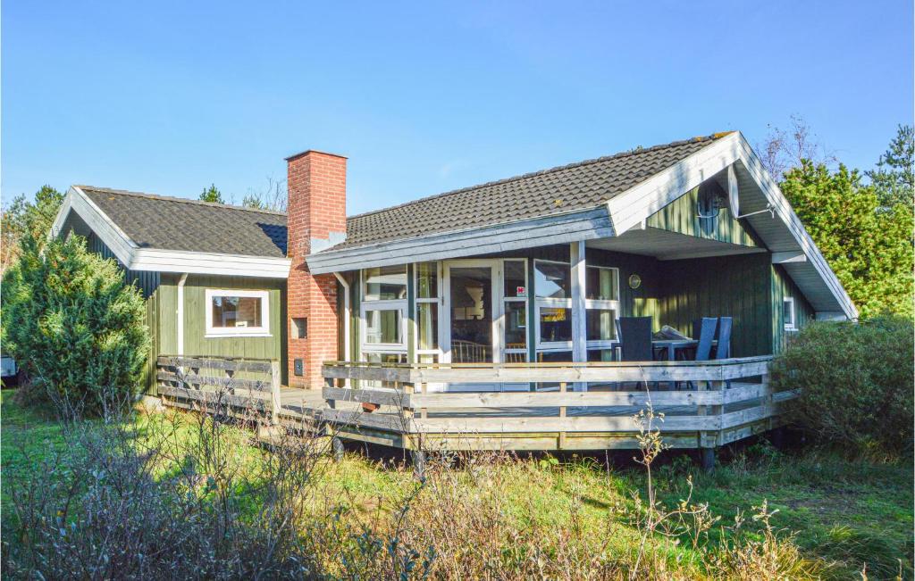 a house with a porch with chairs on it at Holiday Home Kromosevej Rømø Denm in Rømø Kirkeby