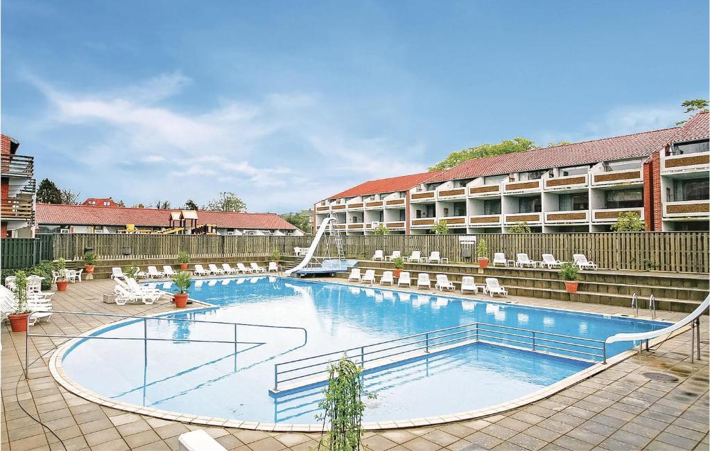 a large swimming pool in front of a hotel at Feriecenter Klinten in Faaborg