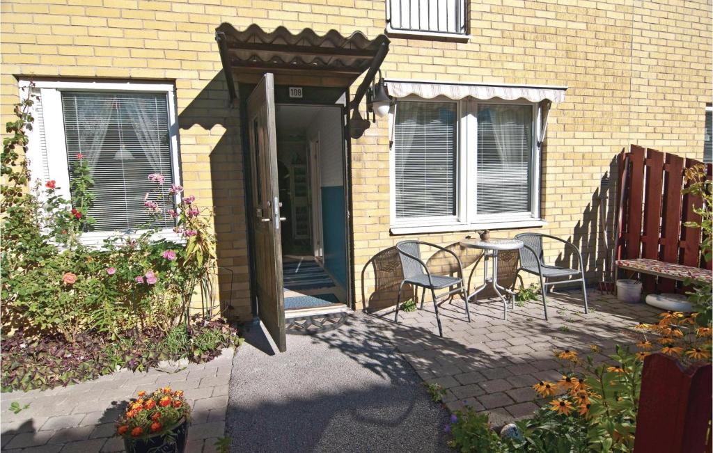 a house with a porch with chairs and a table at Awesome Apartment In Visby With 1 Bedrooms And Wifi in Visby