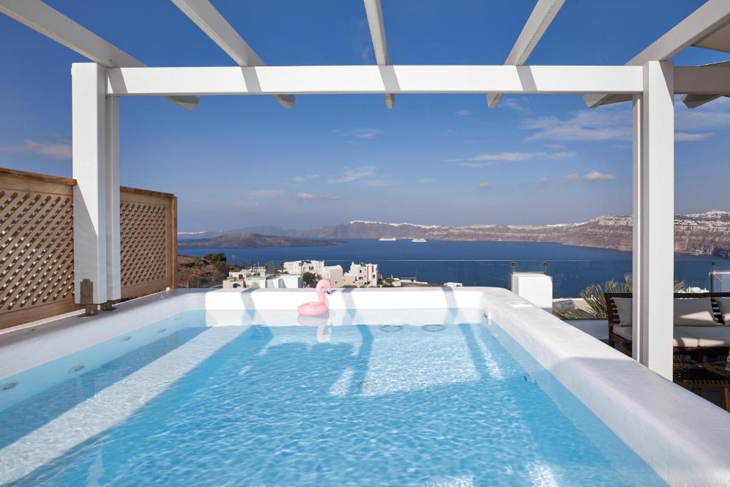 a swimming pool with a view of the water at Admiral's House Santorini in Akrotiri