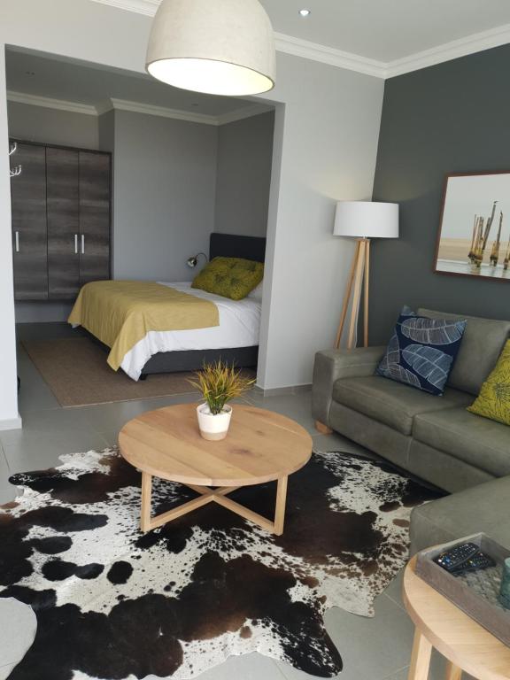 a living room with a bed and a coffee table at Bayview Suites, Unit 9, Room # 13 in Langstrand