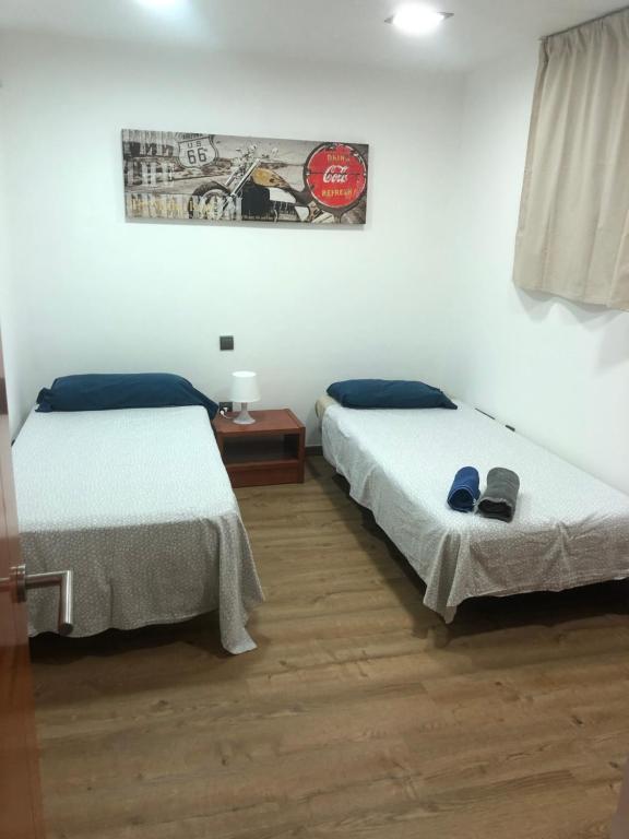 Postel nebo postele na pokoji v ubytování Ílios Soho Apartamentos