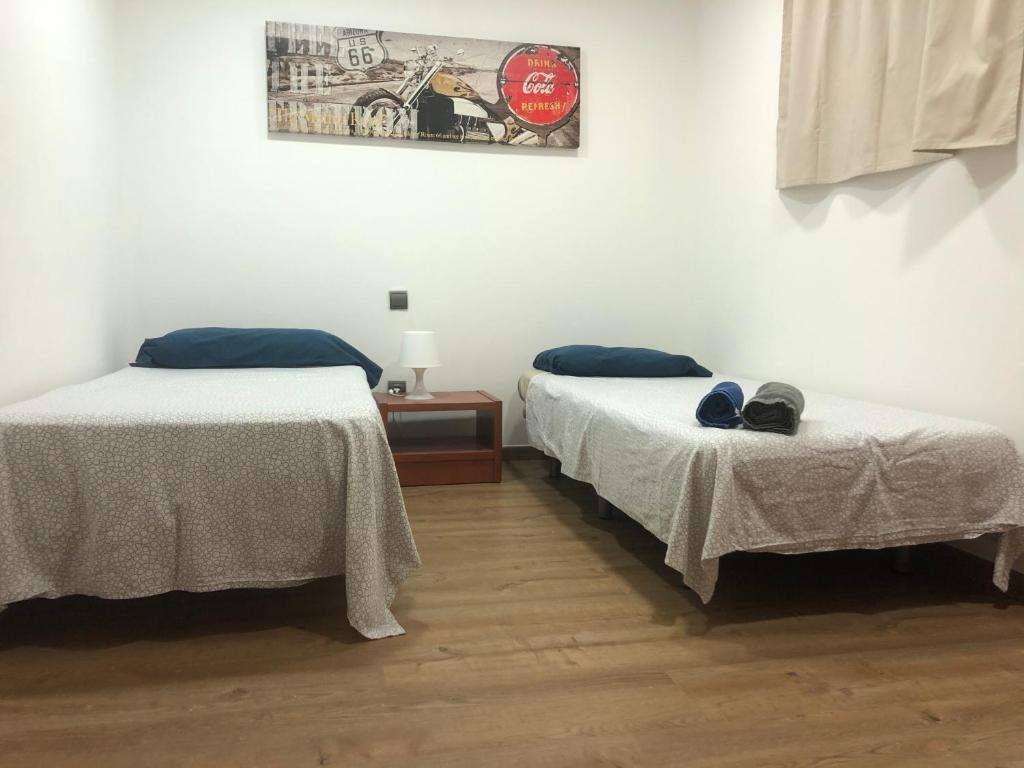 Postel nebo postele na pokoji v ubytování Ílios Soho Apartamentos