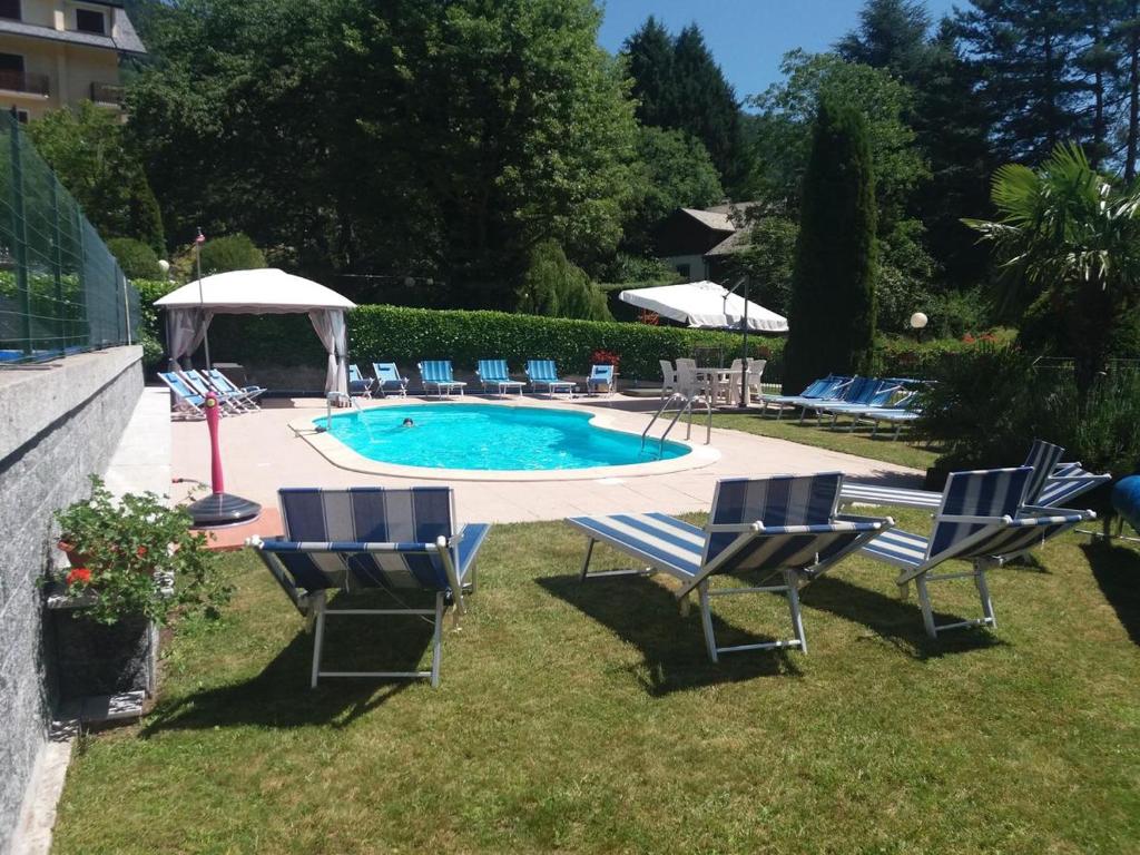 a group of chairs sitting around a swimming pool at RESIDENZA VALLE VIGEZZO in Santa Maria Maggiore