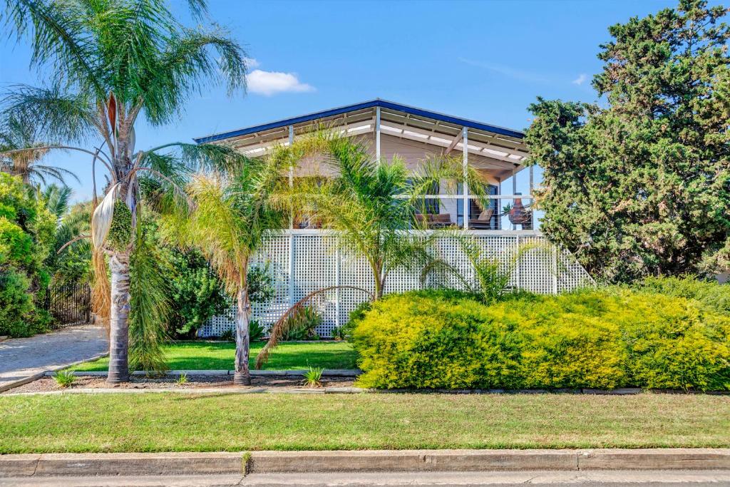 a house with palm trees in front of it at Zephyr Shores - Port Willunga - C21 SouthCoast Holidays in Port Willunga