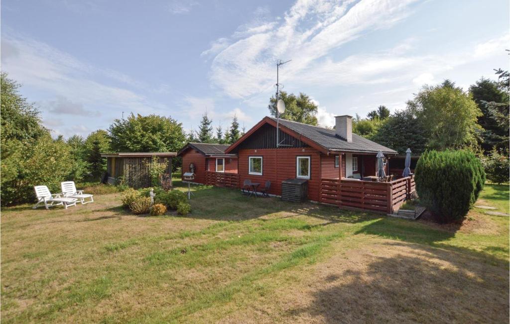 a log cabin with a yard in front of it at Beautiful Home In Vig With 3 Bedrooms And Wifi in Vig