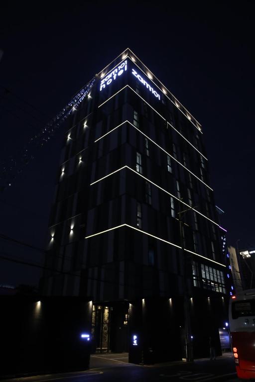 a building with lights on top of it at night at Zam 101 in Busan