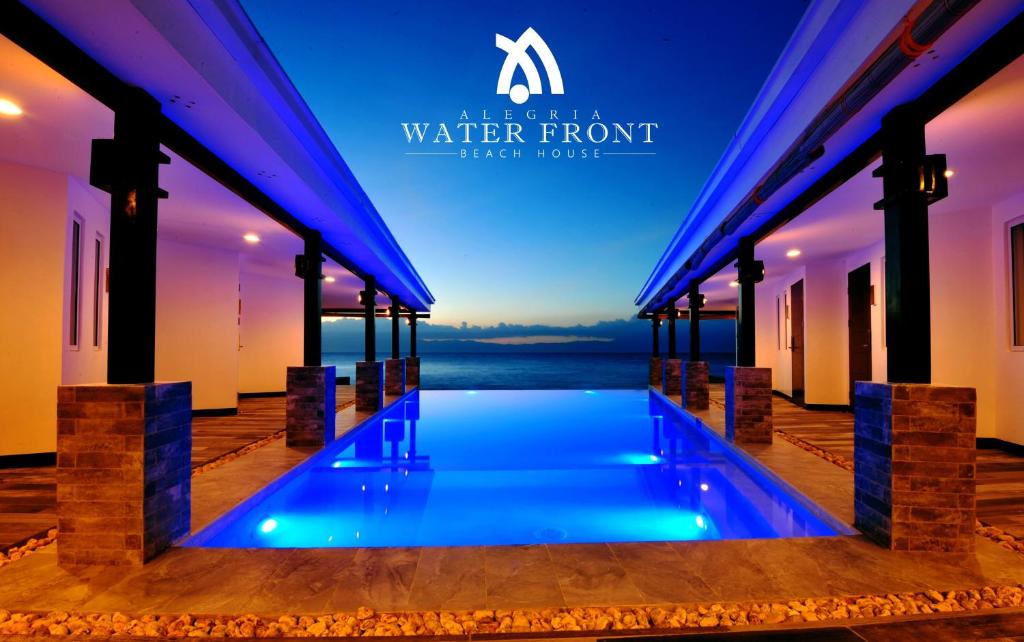 a swimming pool in a villa with a water front at Alegria Water Front Beach House in Alegria