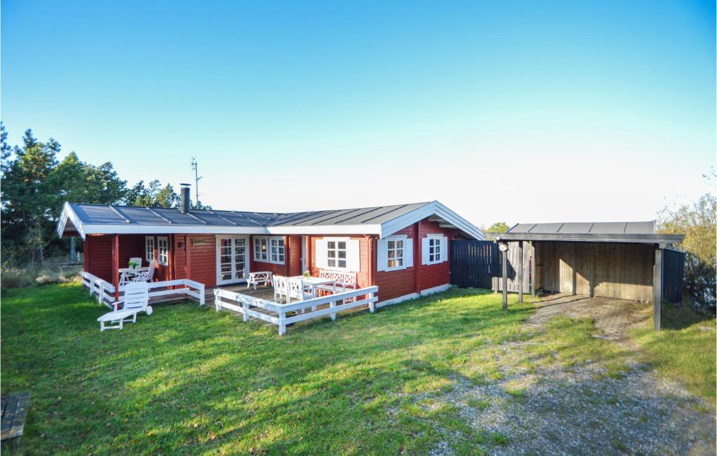 a small red house with a yard and a house at Gimle in Bolilmark