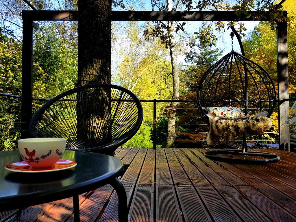 a patio with a table and a chair and a bird cage at U Hanki in Żywiec