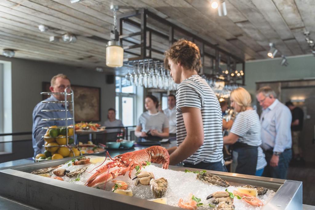 a group of people standing around a buffet with food at Chainlocker in Falmouth