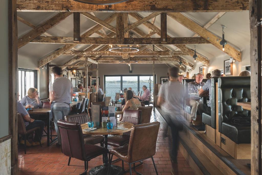 a group of people sitting at tables in a restaurant at Chainlocker in Falmouth
