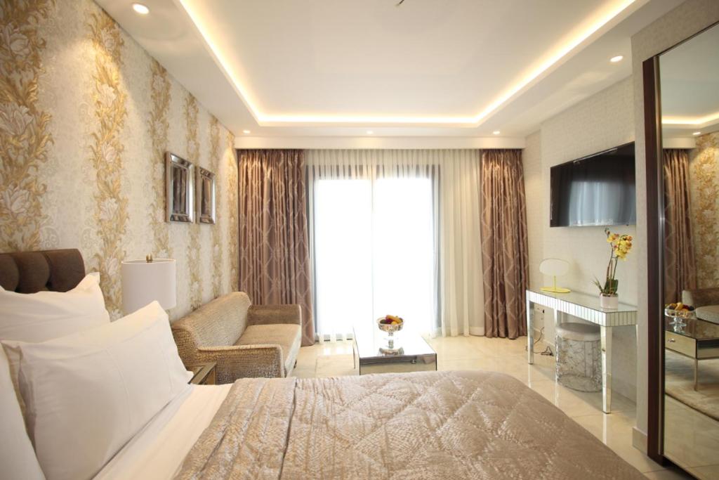 a bedroom with a bed and a living room at APARTMENTS GH - Accra - Airport Residential Area - Mirage Residence in Accra