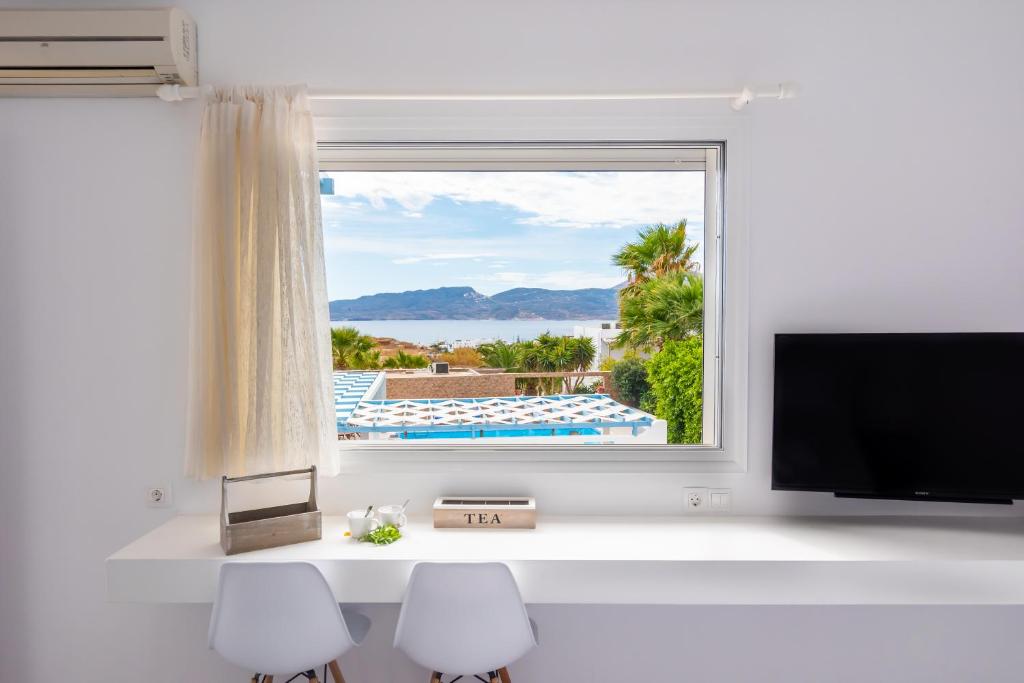 a room with a window with a view of a pool at Orizontes Boutique Studios in Adamantas