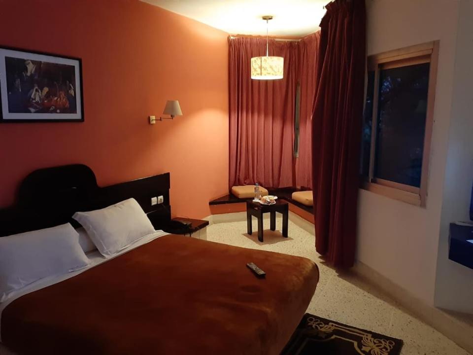 a hotel room with a bed and a window at HOTEL CONTINENTAL Kh&eacute;nifra in Khenifra